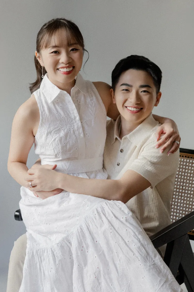 The couple smiling together in their engagement portrait.