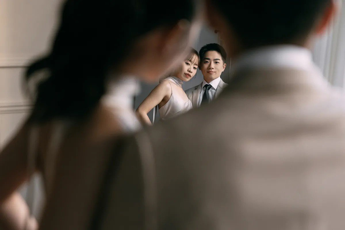 An intimate portrait of the couple reflected in a mirror.